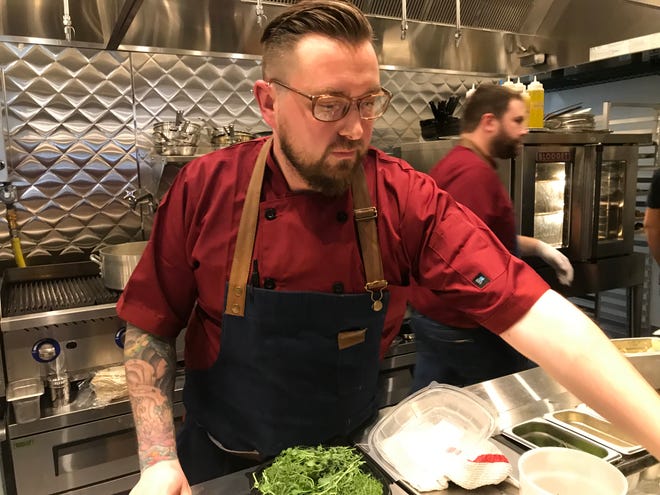 Chef Elliot Checinski works the line at LouVino on Mass Ave. The restaurant is one of 65 donating a portion of its sales on April 25 to The Damien Center, an Indianapolis-based HIV/AIDS support and care organization.