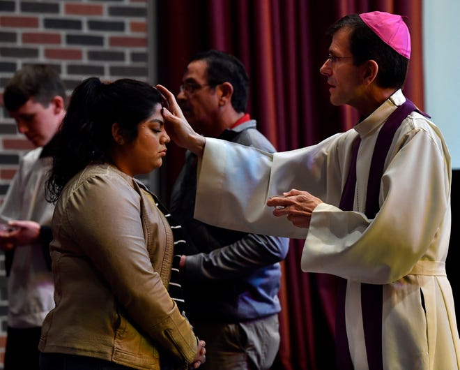 Maria Hernandez receives ashes from Bishop Michael Sis of the Catholic Diocese of San Angelo on Ash Wednesday at Hardin-Simmons University. The bishop also was scheduled to hold services at McMurry and Abilene Christian universities later in the day.