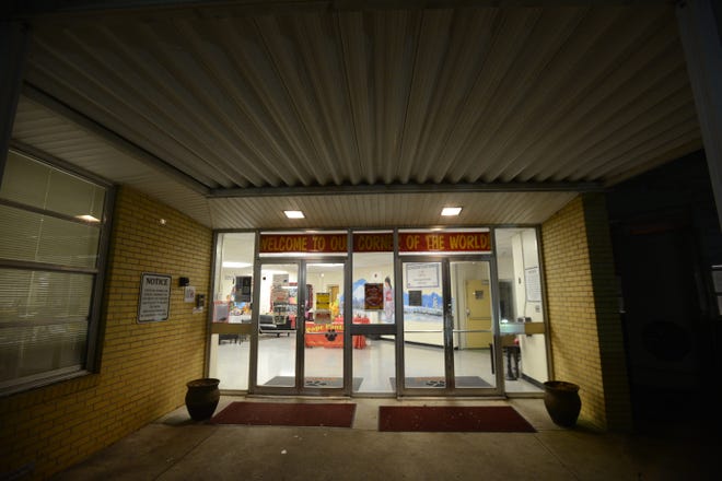 The entrance to Pope Elementary School is lit from the inside after the end of Tuesday night's PTO meeting.