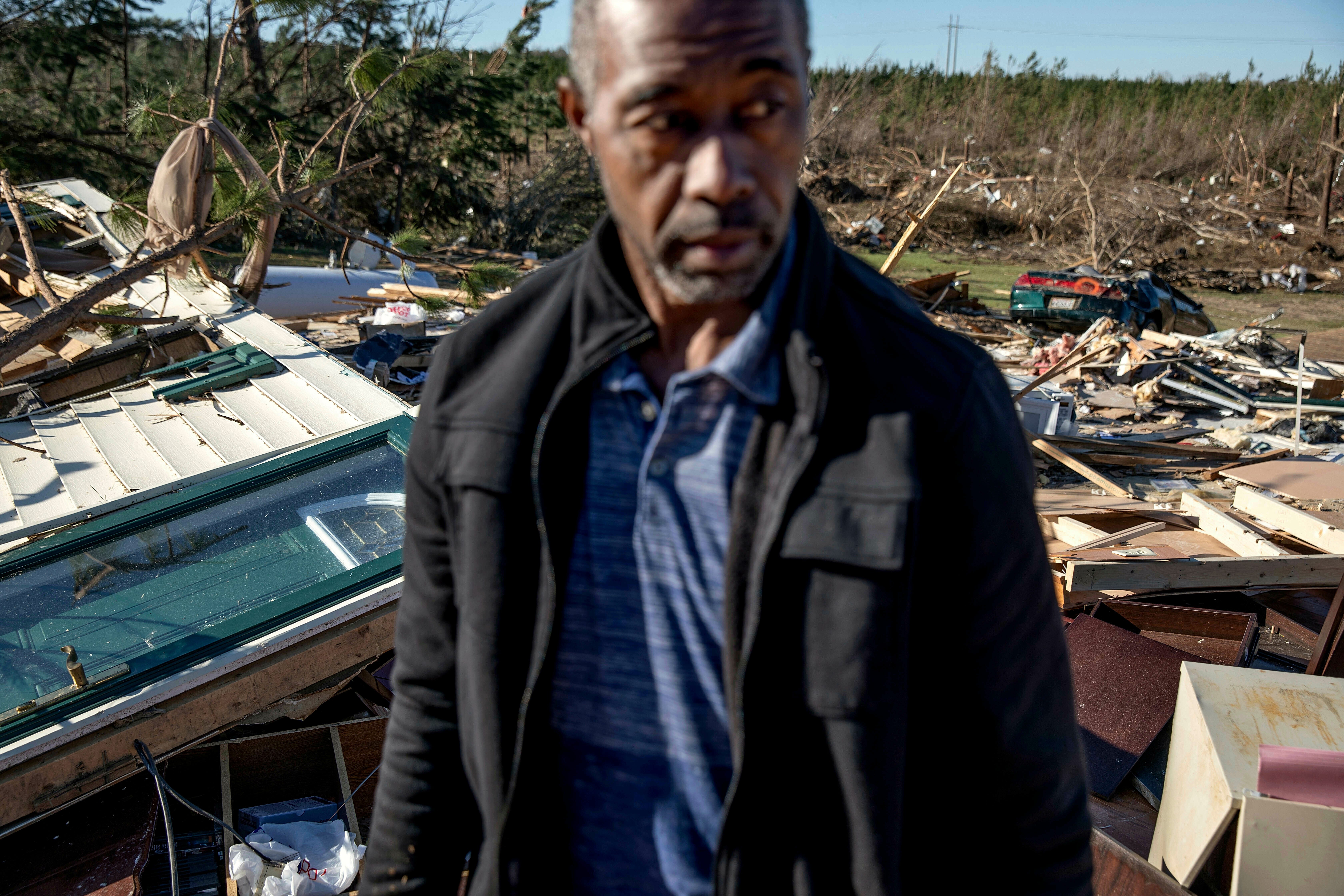 Richard Tate stands amid what's left of his home where he survived a tornado with his wife March 5, 2019 in Beauregard, Ala.