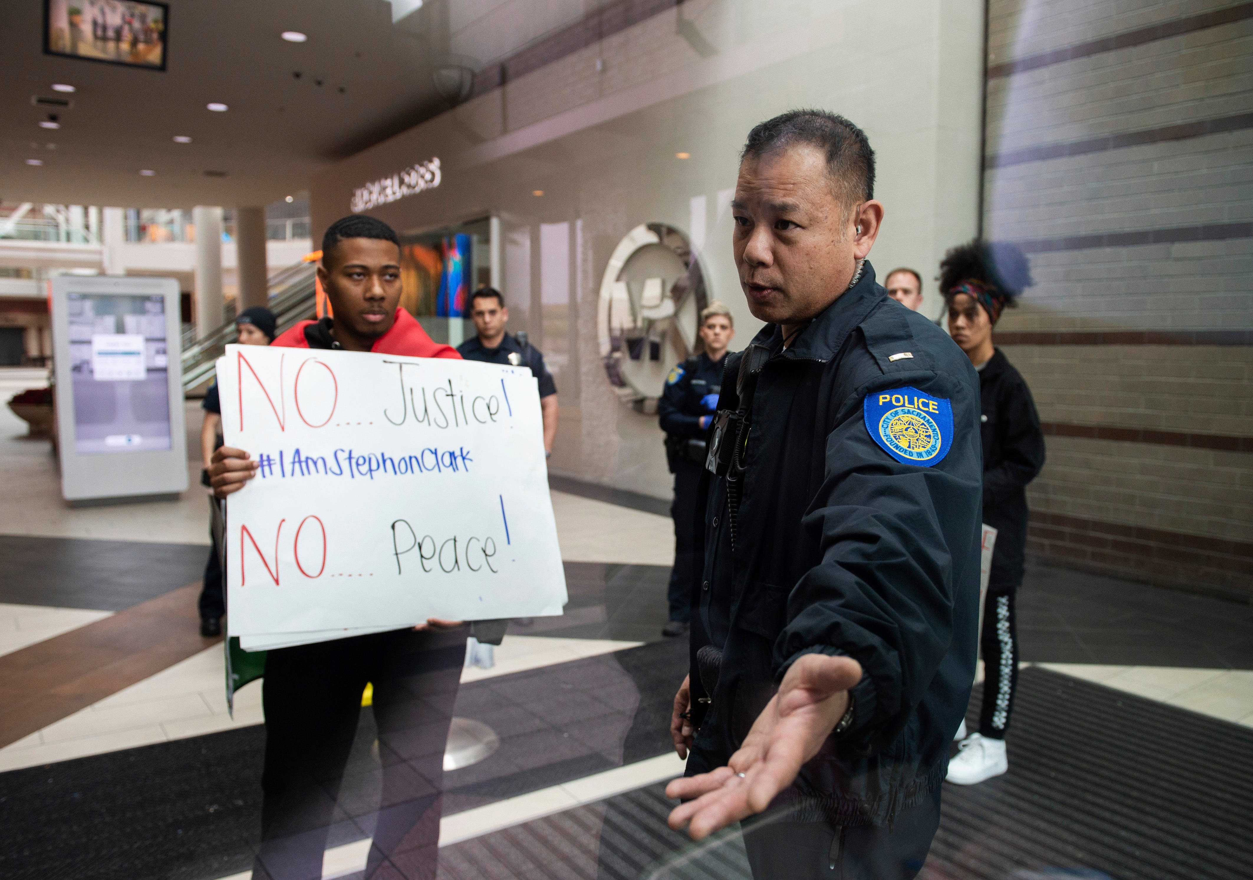 Sacramento Police officers escort protesters from the Arden Fair Mall after they staged an overnight sit-in for Stephon Clark, who was killed by police, in Sacramento, Calif., Sunday, March 3, 2019, following the Sacramento District Attorney's decision not to charge officers involved in last year's shooting of Clark. 