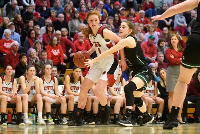 CVU's Catherine Gilwee (4) drives to the hoop past Rice's Sadie Vincent (3) during the girls semifinal basketball game between the Rice Green Knights and the Champlain Valley Union Redhawks at Patrick Gym on Wednesday nigh March 6, 2019 in Burlington, Vermont.