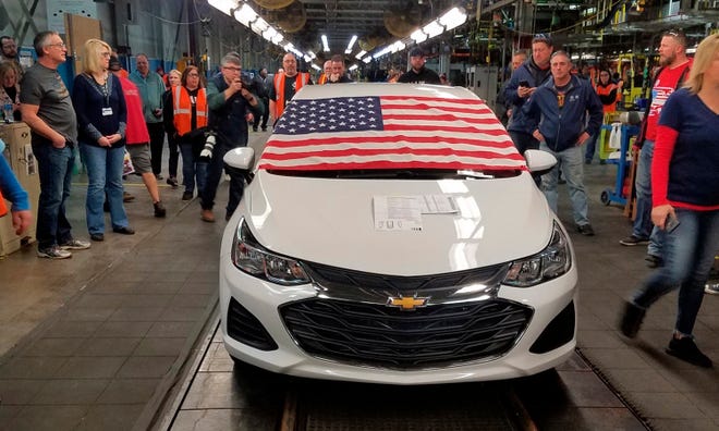 An American flag drapes the hood of the last Chevrolet Cruze as it comes off the assembly line at a General Motors plant where 1,700 hourly positions are being eliminated perhaps for good, on Wednesday, March 6, 2019, in Lordstown, Ohio. The factory near Youngstown is the first of five North American auto plants that GM plans to shut down by next year.