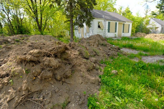 Fresh piled dirt is seen near a vacant home on Faust near Constance in Detroit after a demolition on May 18, 2016.
