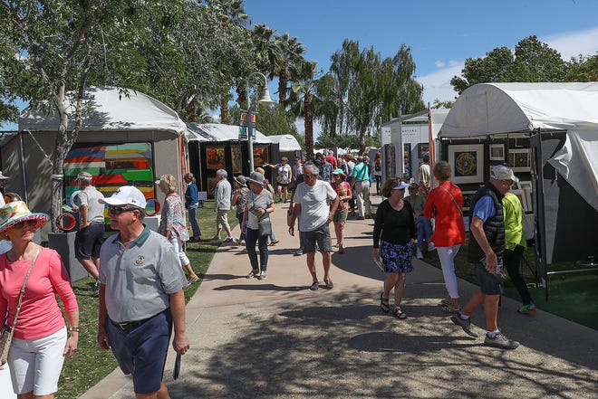 Visitors to the La Quinta Arts Festival check out the artwork, March 7, 2019.