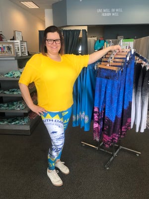 South Dakota Threads manager Jessica Johnson wears a pair of the South Dakota state flag yoga pants featured at the store.