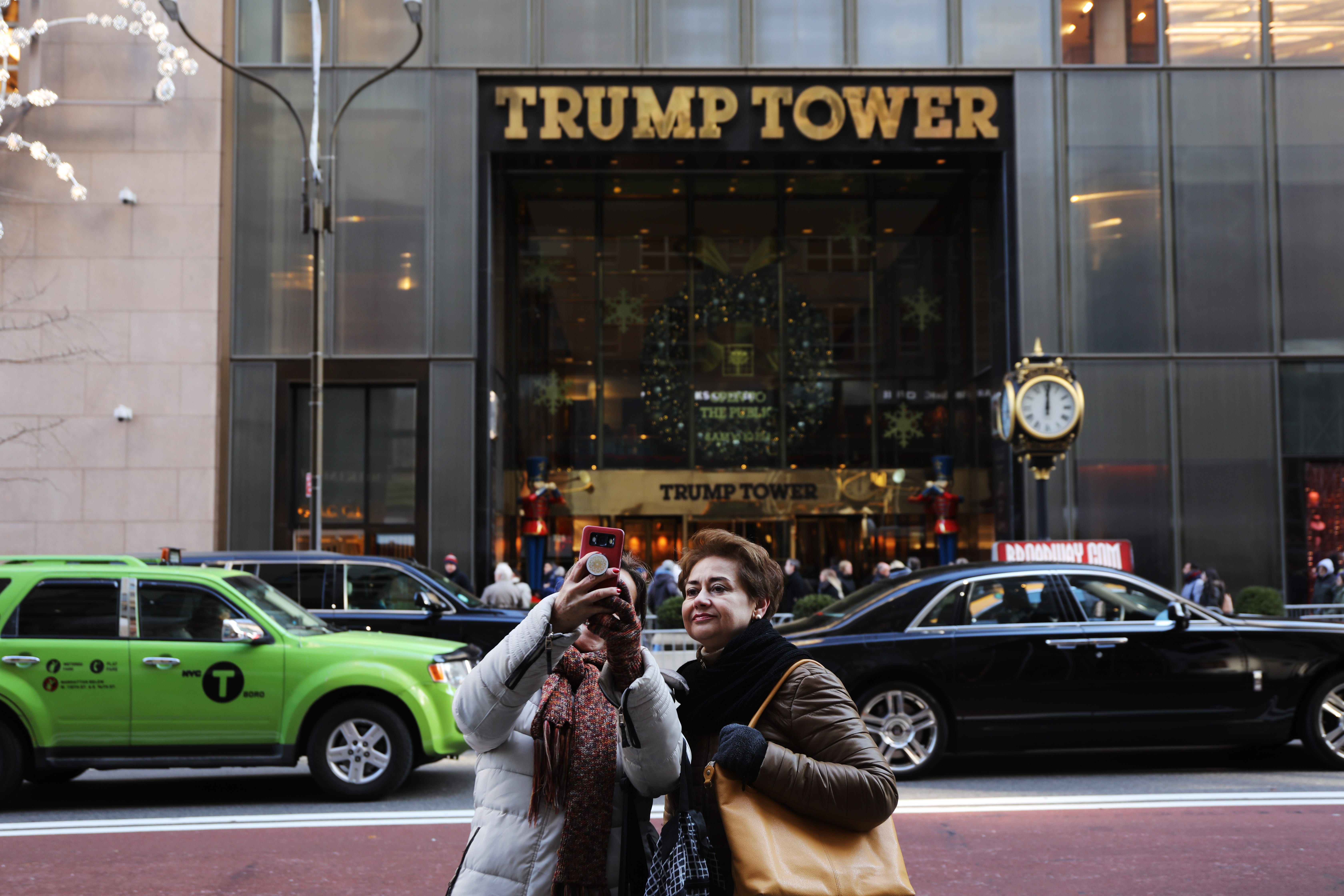 People walk by Trump Tower in Midtown Manhattan on Dec. 10, 2018.