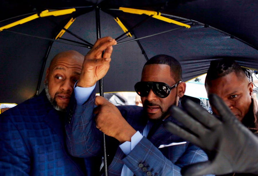 Music artist R. Kelly, center, arrives at the Circuit Court of Cook County, Domestic Relations Division on March 6, 2019 in Chicago, Ill.  Kelly denied allegations he sexually abused women and girls in his first public comments since being indicted last month. "I didn't do this stuff. This not me," Kelly told "CBS This Morning", saying he was "fighting" for his life in an interview to air Wednesday. Excerpts were released Tuesday. 