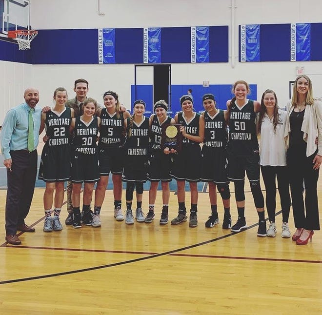 The Heritage Christian girls basketball team, shown celebrating a regional championship, made the 2A state tournament with eight players.