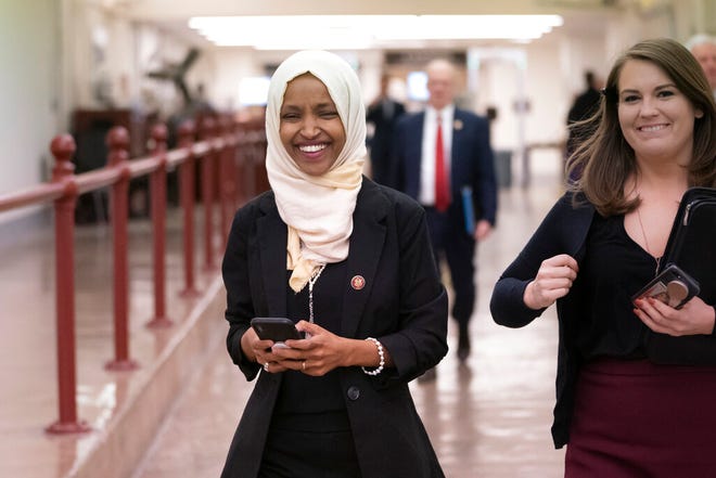 Rep. Ilhan Omar, D-Minn., walks to the chamber Thursday, March 7, on Capitol Hill in Washington, as the House was preparing to vote on a resolution to speak out against, as Speaker of the House Nancy Pelosi said, "anti-Semitism, anti-Islamophobia, anti-white supremacy and all the forms that it takes," an action sparked by remarks from Omar.