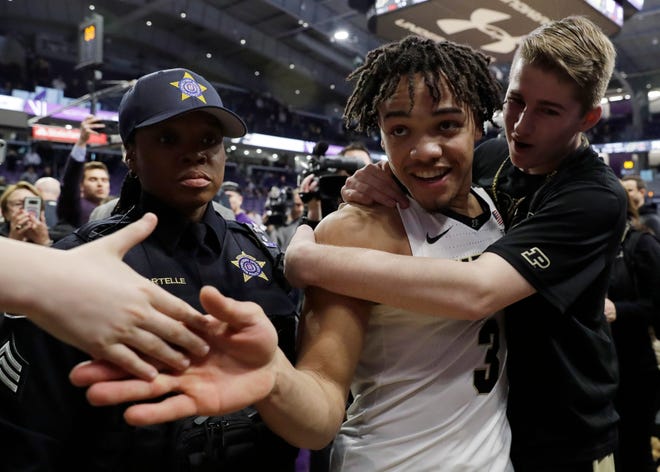 Purdue guard Carsen Edwards (3) celebrates with fans after Purdue defeated Northwestern 70-57 Saturday to clinch a share of the Big Ten regular-season title and the No. 2 seed in the conference tournament.