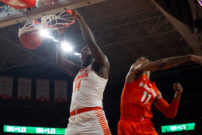Clemson Tigers forward Elijah Thomas (14) dunks the ball while being defended by Syracuse Orange forward Oshae Brissett (11) during the Tigers 67-55 win Saturday at Littlejohn Coliseum.