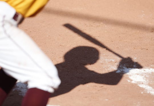 A shadow of a Mountain Pointe batter during a high school softball game at Mountain Pointe on March 23, 2018.