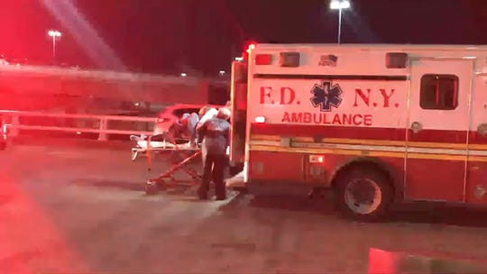 In this still image taken from a video provided by WNBC-TV News 4 in New York, emergency medical personnel are caring for a wounded passenger of a Turkish Airlines plane at the International Airport John F. Kennedy from New York on Saturday, March 9, 2019.