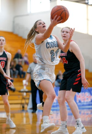 Lansing Catholic's Devan Buda goes up for a layup against Jackson Northwest's Anya Hedrich, Monday, March 11, 2019, in Ionia, Mich.