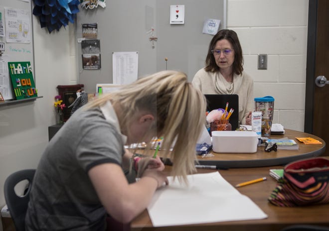 Shannon Cox, Johnstown's In-School-Support teacher, works at her desk as freshman Never Lash works on an art project. Cox started off as an In-School-Suspension teacher but has been so effective at her job she has shifted into a support role, helping kids before they cause trouble.