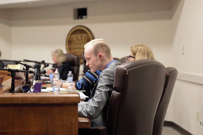NMSU student body President Emerson Morrow checks his laptop during the March 8, 2019 meeting of the board of regents.
