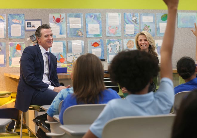 Gov. Gavin Newsom accompanied by his wife, Jennifer Siebel Newsom, take questions from sixth graders at the Washington Elementary School in Sacramento on Friday, March 1. California's first couple visited the school to celebrate Read Across America Day.