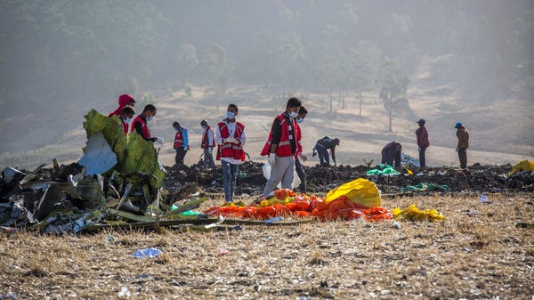 Rescuers work at the scene of an Ethiopian...