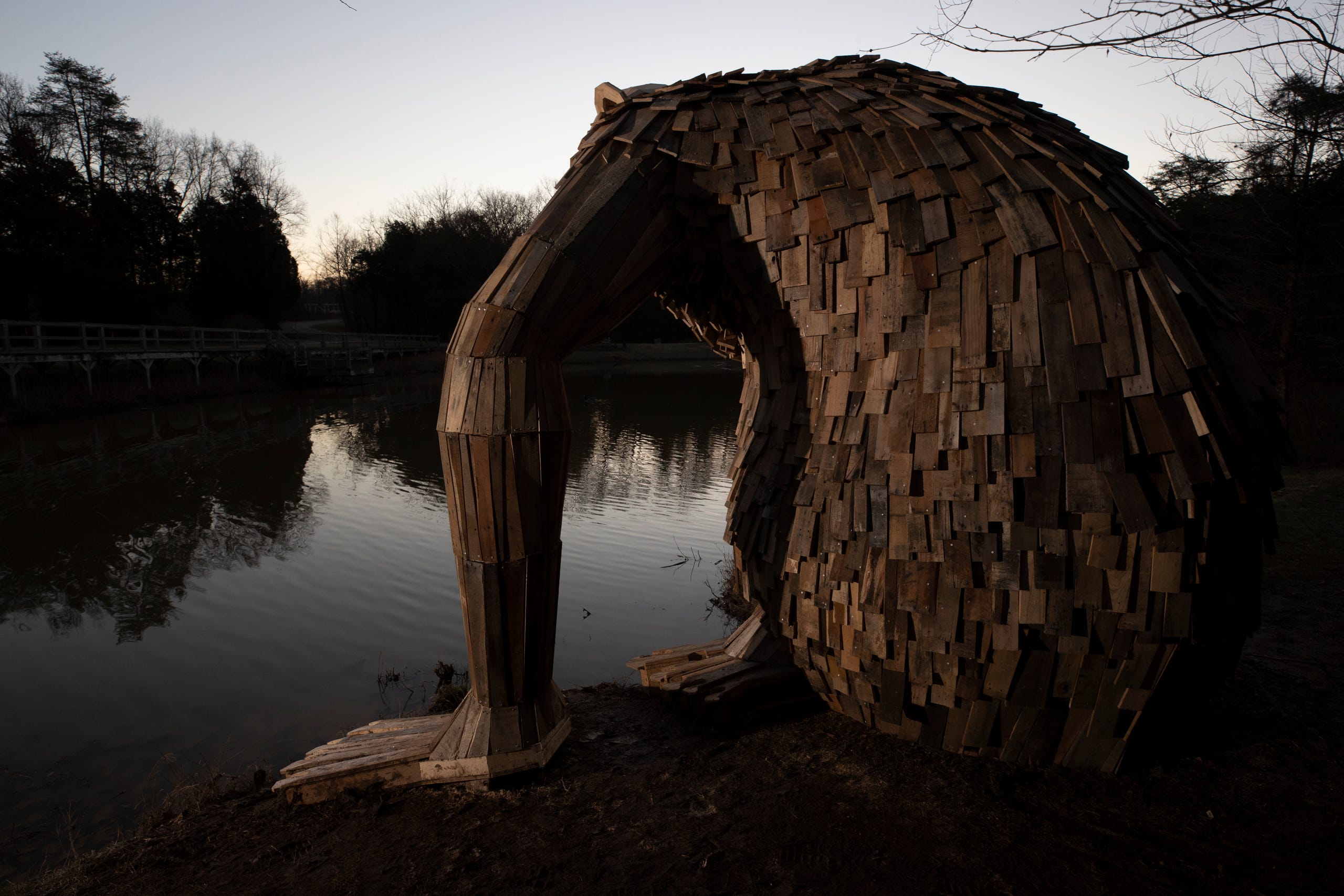 "Little Nis," gazes into the waters of Holly Pond at Bernheim Forest. His is one of three giant trolls created by sculptor Thomas Dambo. Feb. 27, 2019