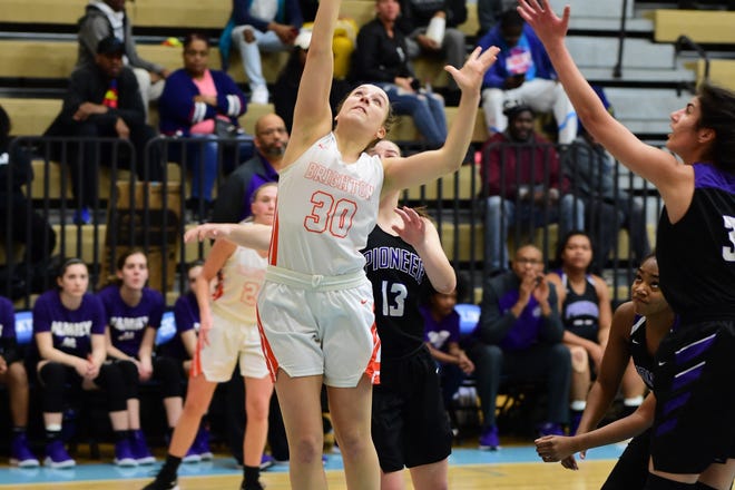 Brighton senior Lauren Brown goes up for a basket against Ann Arbor Pioneer on March 11, 2019.