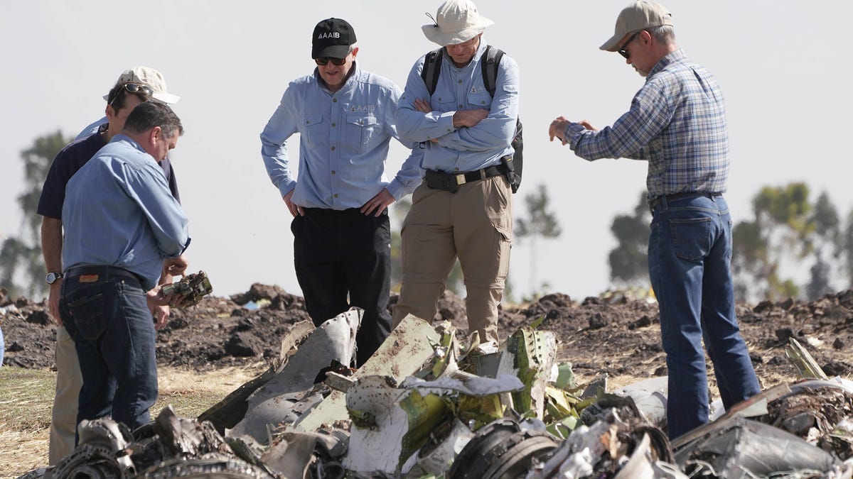 Investigators with the U.S. National Transportation and Safety Board look over debris at the crash site of Ethiopian Airlines Flight 302 on March 12, 2019, in Bishoftu.