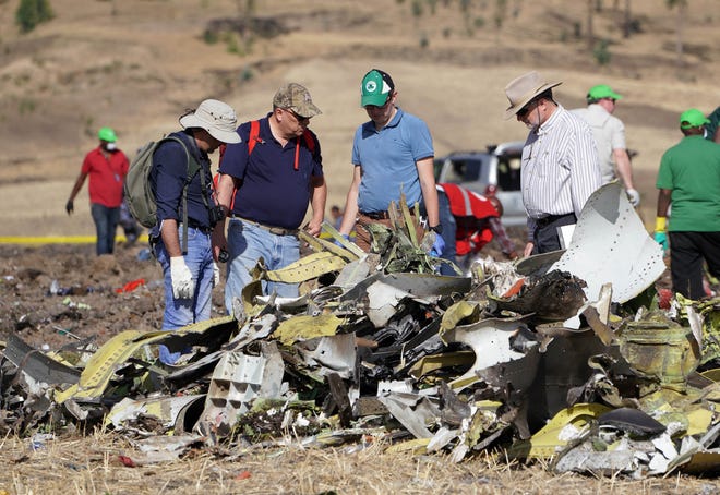 Investigators with the U.S. National Transportation and Safety Board look over debris at the crash site of Ethiopian Airlines Flight 302 on March 12, 2019, in Bishoftu, Ethiopia.