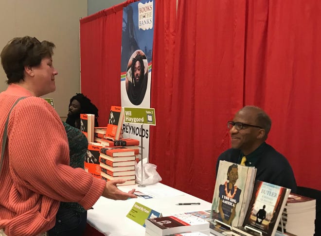 A fan talks to author Wil Haygood during the 2018 Books by the Banks event.