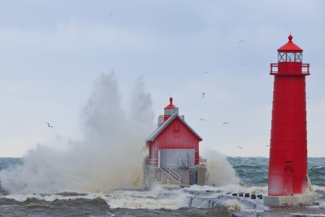 Large waves from Lake Michigan batter the Grand Haven South Pier and Lighthouse in Grand Haven.