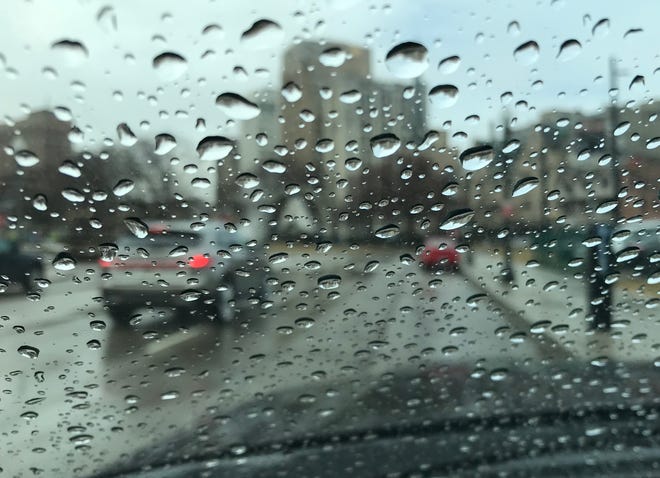 Raindrops fall on a windshield in Detroit.