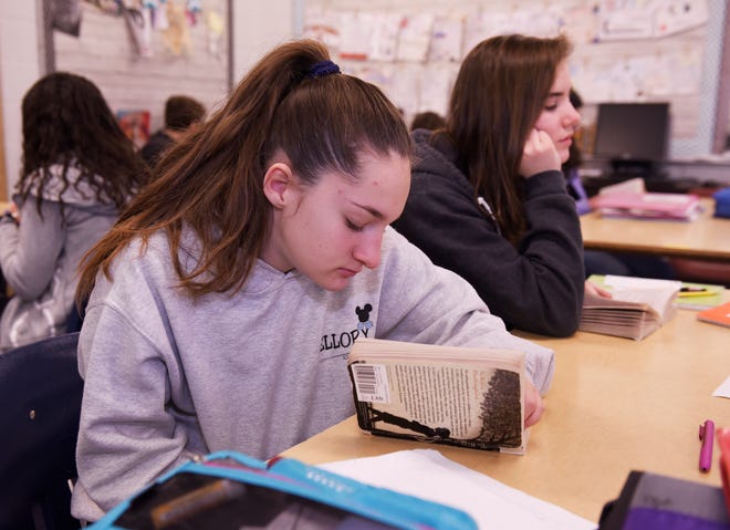 Maddy Pitler, 14, reads her book assignment during 8th grade language and literature class class at Norup Middle School in Royal Oak.