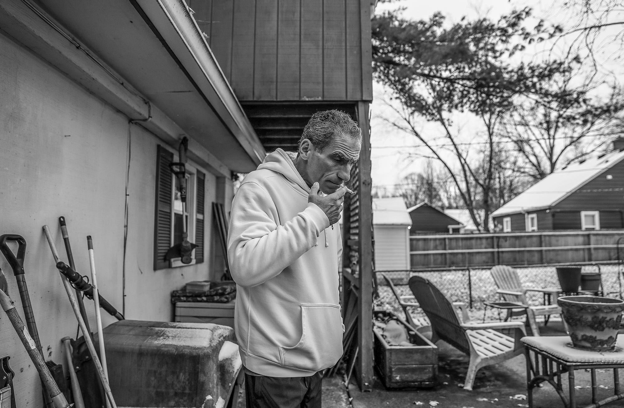 After his morning reading, Mat Pazzarelli has a cigarette at his home in Indianapolis on Wednesday, Dec. 5, 2018.