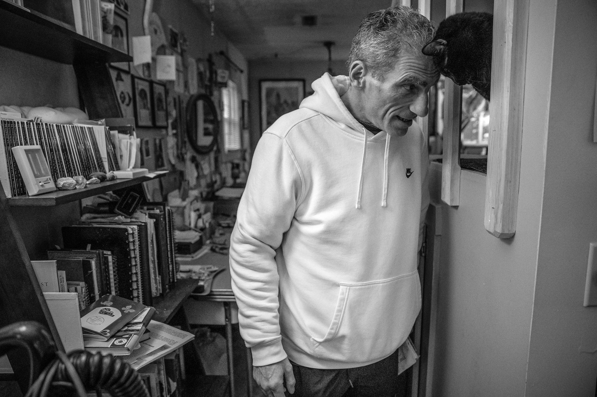 Mat Pazzarelli says goodbye for the day to his cat, Indy, on Wednesday, Dec. 5, 2018. Pazzarelli named his cat after the city of Indianapolis, the second permanent city he lived in during his time in witness protection. "The witness protection program might have had a responsibility for my security, for financial concern and medical help," said Pazzarelli. "The minute I got here I knew."