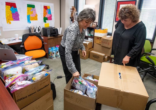 Dallas Rabig, of the Department of Early Childhood Education, left, gives child comfort kits to Kelly Hodges, of the Red Cross, on Wednesday March 13, 2019 in Montgomery, Ala., to be distributed to children in the wake of the Lee County tornados.