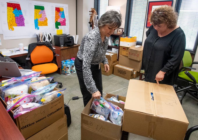 Dallas Rabig, of the Department of Early Childhood Education, left, gives child comfort kits to Kelly Hodges, of the Red Cross, on Wednesday March 13, 2019 in Montgomery, Ala., to be distributed to children in the wake of the Lee County tornados.