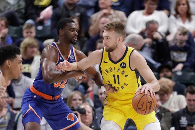 Indiana Pacers' Domantas Sabonis (11) is defended by New York Knicks' Noah Vonleh (32) during the first half of an NBA basketball game Tuesday, March 12, 2019, in Indianapolis. (AP Photo/Darron Cummings)