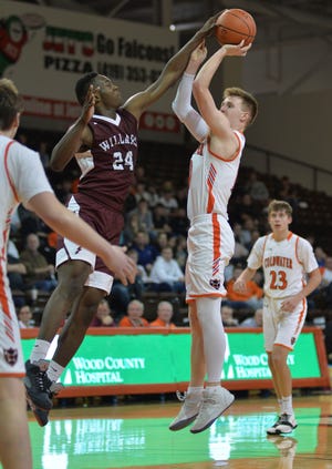 Willard's Davon Triplett, who will be playing in the 41st News Journal All-Star Classic on March 29 at Lexington High School, blocks a shot by Coldwater's Marcus Bruns during Wednesday's Division III regional semifinal game in Bowling Green's Stroh Center.