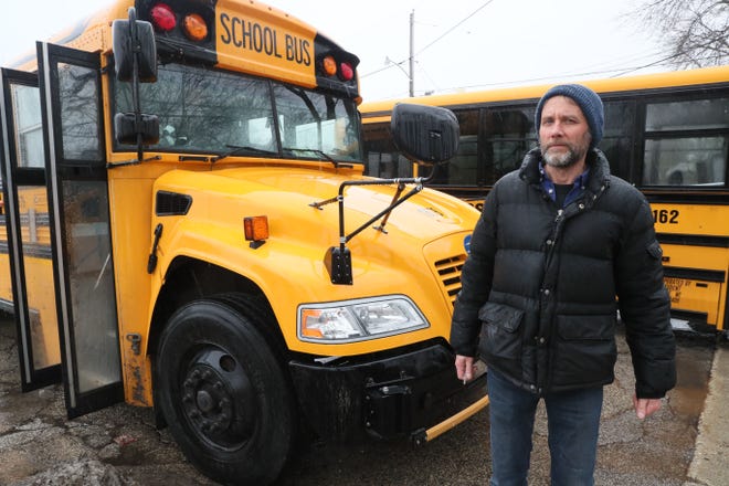 Bus driver Steve Fendt waits for the children to finish boarding his bus at Gaenslen School in Milwaukee on Thursday.