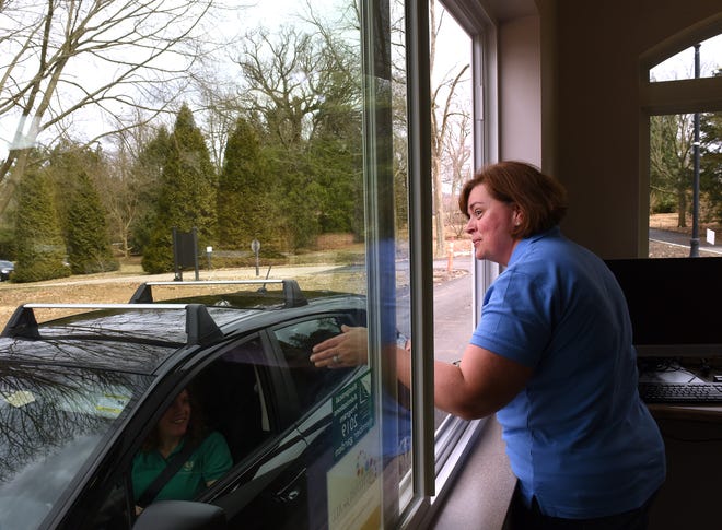 Dawes Arboretum guest services manager Kelley McCormack helps director of development Leigh Ann Miller practice the new entrance procedure for the arboretum. Starting April 15, 2019 entrance fees will be $10 for adults (15-years-old and older), $5 for children 5-15 years-old, and free for children 5 and under. Annual memberships are $60 for a family and $40 for an adult and a guest. Visitors with a Supplemental Nutrition Assistance ProgramÊcard will be admitted forÊ$3 per person.