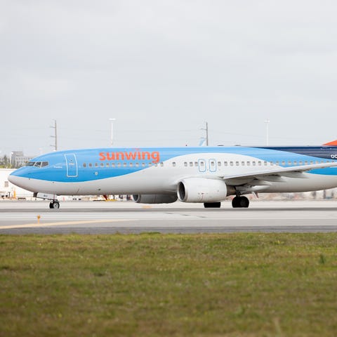 A Sunwing Boeing 737-800, bearing a cross-over liv