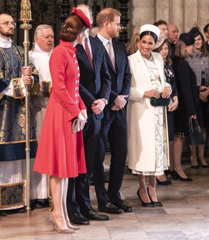Duchess Kate of Cambridge talks with Duchess Meghan of Sussex, with husbands Prince William and Prince Harry, at the Commonwealth Day service at Westminster Abbey, March 11, 2019.