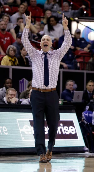 Utah State coach Craig Smith shouts to players during during the second half of the team's NCAA college basketball game against New Mexico in the Mountain West Conference men's tournament Thursday, March 14, 2019, in Las Vegas.