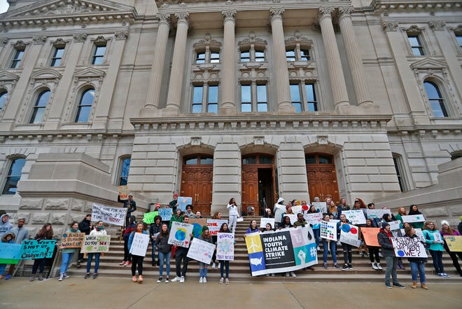 Multiple bills this year are meant to help the state and its agencies address climate change and its local impacts. Here, students gather with signs on the sound steps of the Indiana Statehouse during the Indiana part of the international Climate Strike, Friday, March 15, 2019, held outside the Indiana Statehouse.