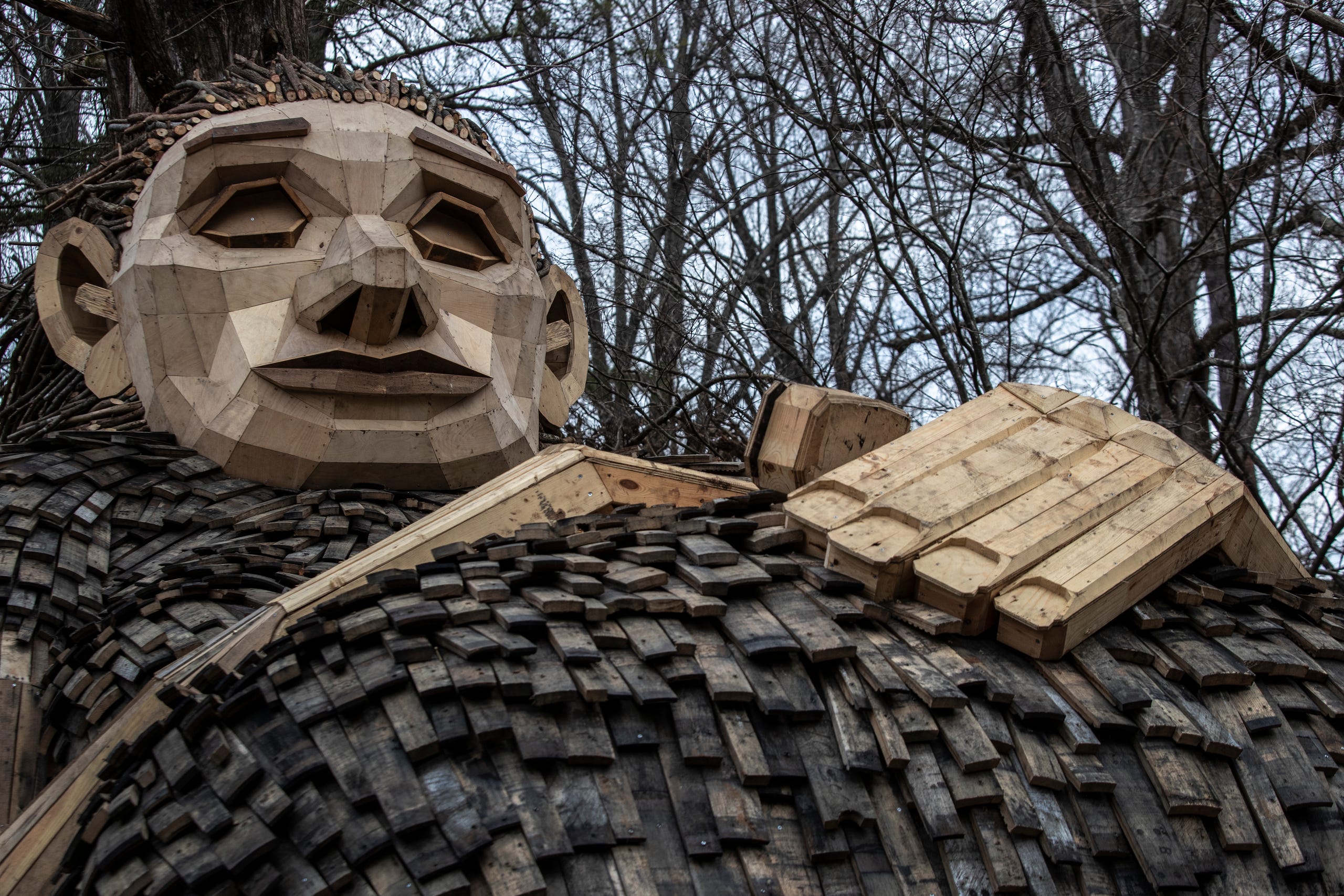 A pregnant Momma Loumari rests against a redwood tree. The giant troll and her two children have taken up residence in Bernheim Forest. The sculpture is the work of Artist Thomas Dambo. March 15, 2019.