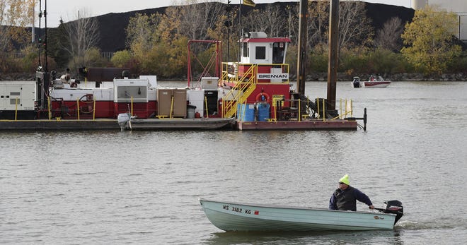 Crews dredging contaminated sediments in the Fox River in Green Bay.