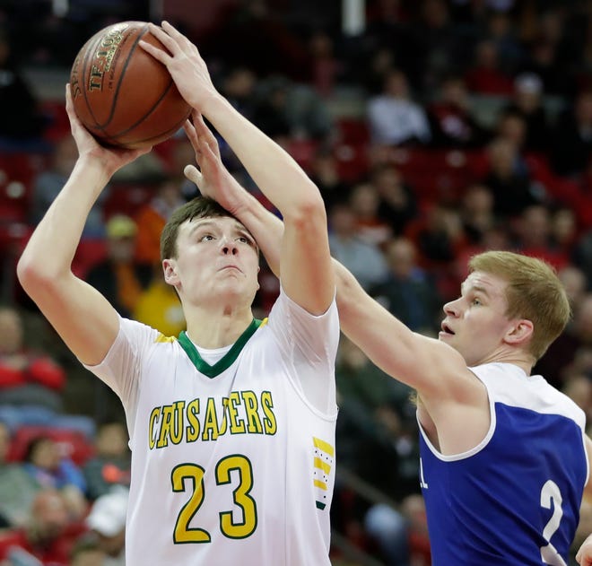 Sheboygan Lutheran's Jacob Ognacevic (23) looks to shoots against McDonell Central Catholic's Cory Hoglund during their WIAA Division 5 boys basketball state semifinal at the Kohl Center on March 15.