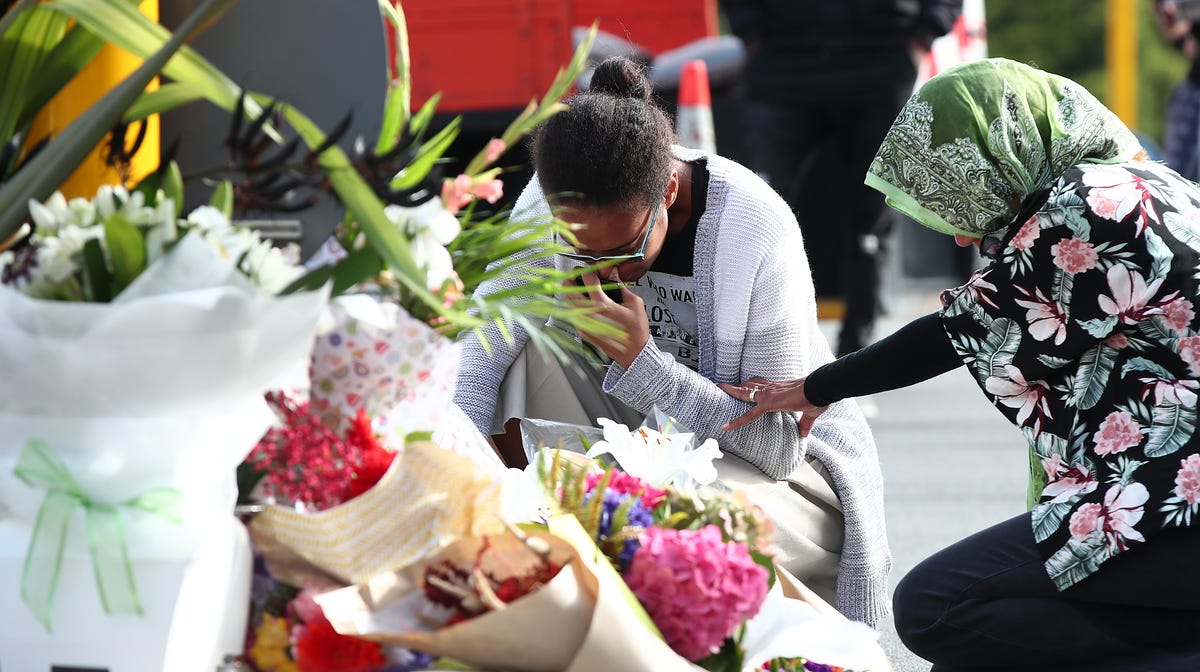 CHRISTCHURCH, NEW ZEALAND - MARCH 16: Locals lay flowers in tribute to those killed and injured at Deans Avenue near the Al Noor Mosque on March 16, 2019 in Christchurch, New Zealand. At least 49 people are confirmed dead, with more than 40 people injured following attacks on two mosques in Christchurch on Friday afternoon. Of the victims, 41 were killed at Al Noor Mosque on Deans Avenue and seven died at the Linwood Mosque. Another victim died later in Christchurch   hospital. Three people are in custody over the mass shootings. One man has been charged with murder.  (Photo by Fiona Goodall/Getty Images) ORG XMIT: 775315734 ORIG FILE ID: 1136041681