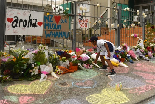 A boy places Flowers outside a Mosque in Kilbirnie, Wellington on March 16, 2019 in Kilbirnie, New Zealand.