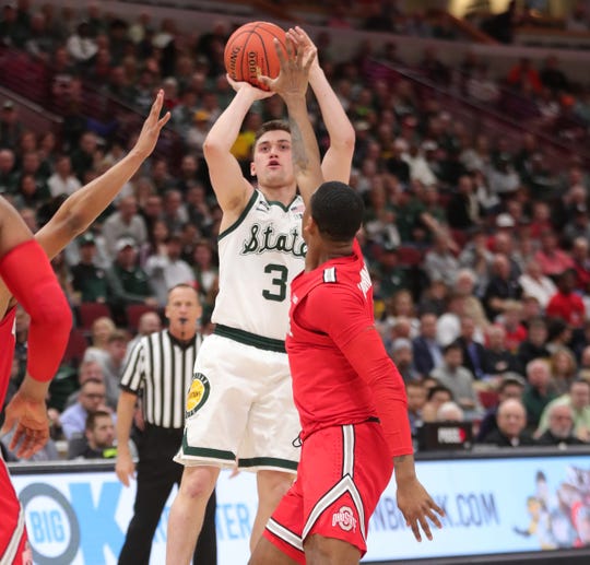 Foster Loyer scores against Ohio State Friday in Chicago.