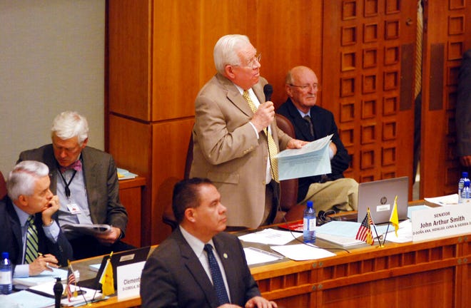 Democratic Sen. John Arthur Smith, of Deming, at center with microphone, guides a $700 million annual spending increase from New Mexico's general fund through approval by the state Senate on Wednesday, March 13, 2019, in Santa Fe, N.M. The House and Senate are moving closer to agreement that would increase spending on public education by nearly half a billion dollars and channel a windfall in tax income toward infrastructure and economic stimulus.